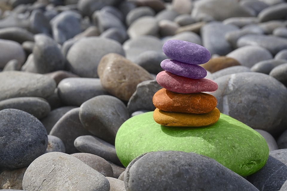 various stones stacked in different colors representing chakras