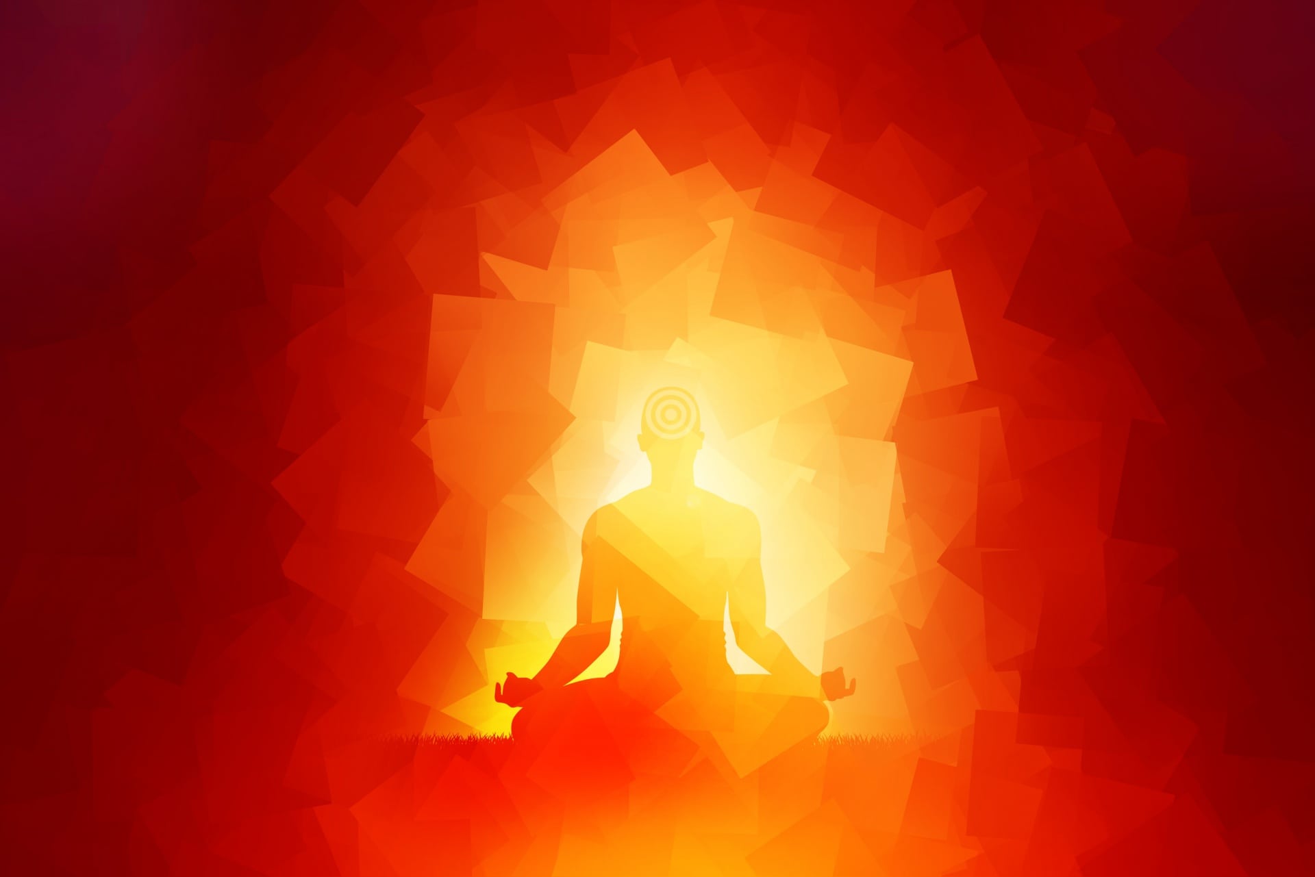 man meditating surrounded by a red and orange aura