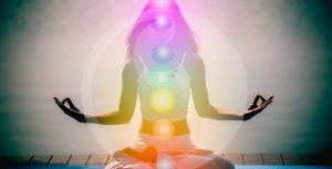 woman meditating glowing 7 chakras
